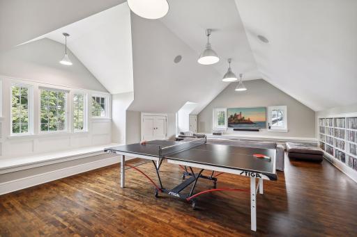 Fabulous third floor renovation which added a vaulted ceiling and three large dormer windows with built-in window seats. This room functions beautifully as a family room, media, room, and game room. Optional 5th bedroom. Storage. Library shelving.