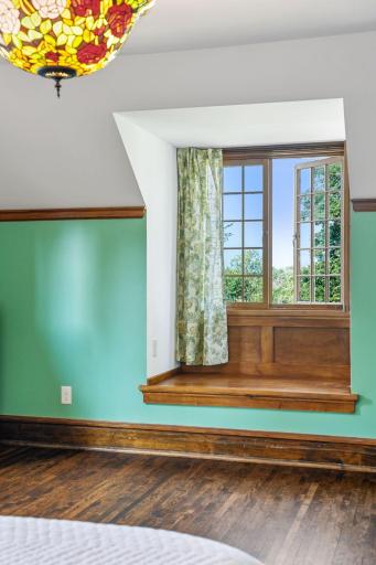 West facing windows in the fourth bedroom with window seat and new windows.