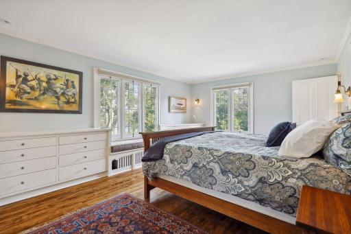 The primary suite enjoys beautiful views of Lake of the Isles, a spacious walk-in closet, built-in cabinetry, and a spa-like full primary bath.