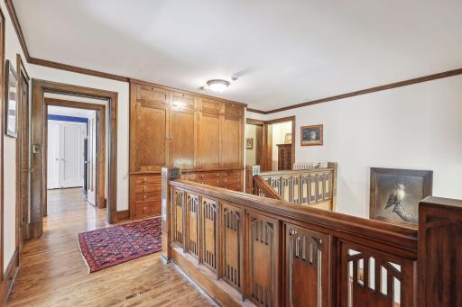 The upper level features original hardwood floors throughout, built-in storage, three bedrooms with designated bathrooms, and a luxurious primary suite.