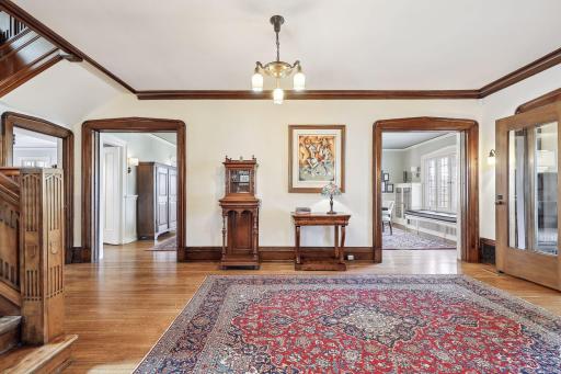 The center hall features original walnut mill work and wide entry ways to the formal living areas and kitchen.