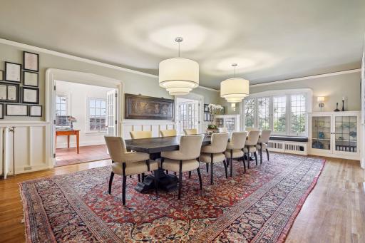 Stunning dining room with lake views. Original built-in cabinetry, butler's pantry, and excellent space for entertaining large groups. A second main level sunroom and front patio are accessible through two sets of French doors.