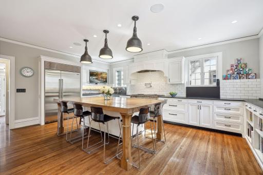 Chef's kitchen renovation with entertaining, family, and informal gatherings in mind. Abundant storage including a pantry with access to the dining room, professional grade appliances, and a nod to the original architectural details.
