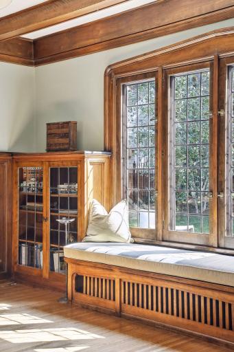 Views of the backyard from the living room. Gorgeous walnut millwork and original hardwood floors throughout.