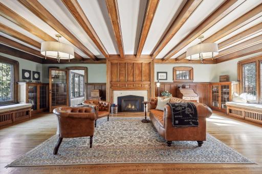 The formal living room features walnut beamed ceilings, a gorgeous gas fireplace mantle and surround, built-in benches, and original built-in cabinetry with beautiful views to the west of the lake and to the east of the back yard. Adjacent sunroom.