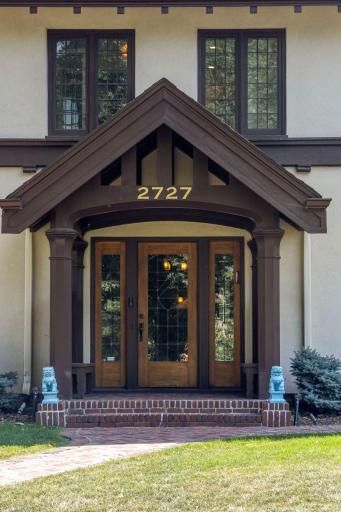 Welcoming covered front entry with built-in benches. Gorgeous front entry door with side lights and divided light windows.