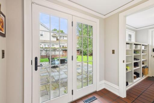 Main level mudroom, back hall powder room, and easy access to the backyard and patio from the kitchen. The mudroom features built-in storage, a bench, and abundant hooks for coats. Backdoor leads to a short walk to the newly built 2.5 car garage.