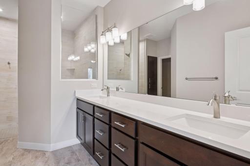 Private primary bedroom - two sinks and no curb walk-in shower.
