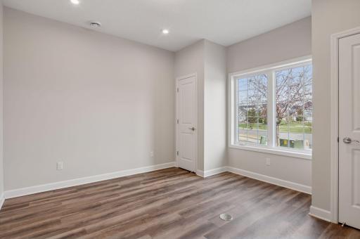 First of two guest bedrooms - this room features two closets with organizers and a front yard view. This space also makes an excellent office / den / family room.