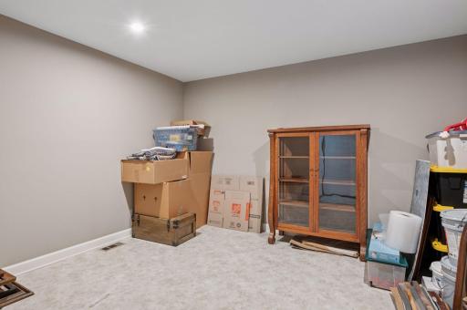 Stairs inside the heated garage lead to this temperature controlled storage room - so helpful!