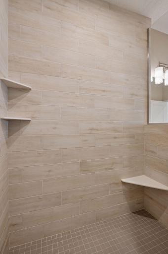 Tiled shower with built-in shelving and bench