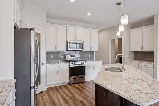 Notice the on-trend cupboard enameling coupled with the warmer woods throughout the home - such a nice combination.