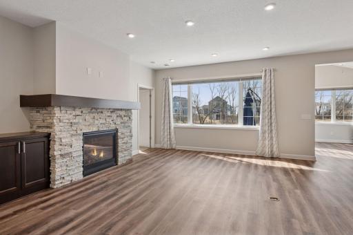 Dynamite living room anchored by pretty gas fireplace, stone surround and mantle with built-ins - all with great backyard views. Stop back on Monday, April 21st to see virtual staging pictures of these lovely spaces.