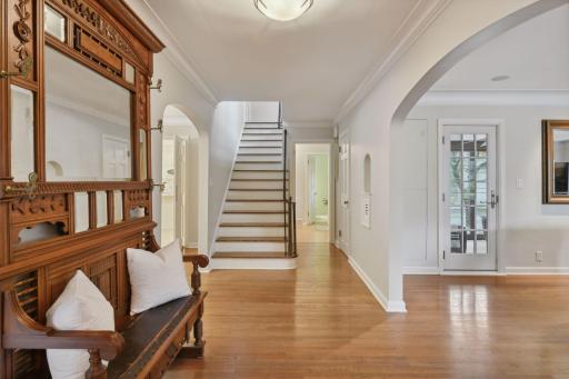 Foyer opens to living room, office, and dining room. Additional coat closets by garage entrance and powder bath.