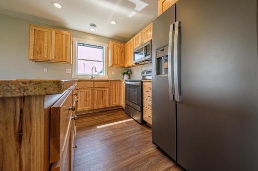 The kitchen features birch cabinets, granite countertops, S.S. appliances, and LVP flooring.