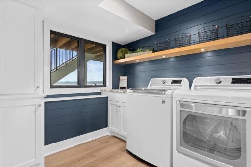 The laundry room on the lower level is great for lake towels and more. Upstairs features a stackable washer and dryer.