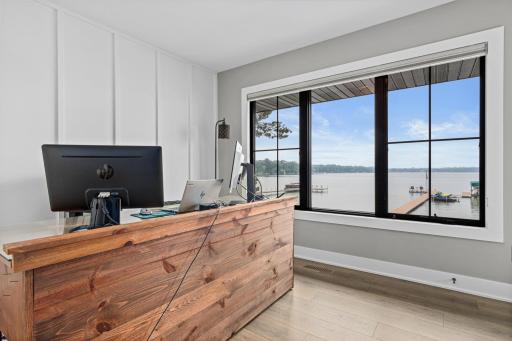 Main level third bedroom overlooking the lake- currently being used as a home office. Also has a door that leads to the deck. Enjoy beautiful views during your work day.