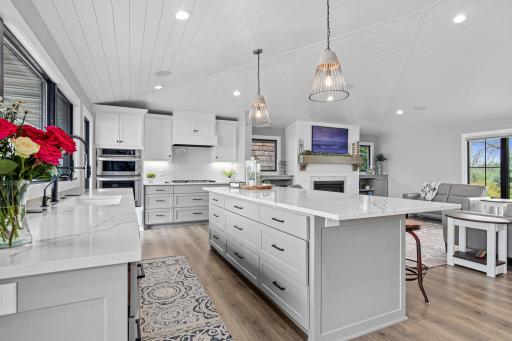 View from the pantry and patio door to the deck. Well-designed space is perfect for entertaining small and large group and makes every day living easy fun and enjoyable. Shiplap ceiling and fireplace tie the space together.