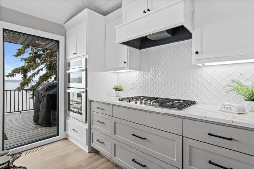 Floor to ceiling window brings in great natural light and views of the lake. Custom cabinetry, solid surface countertops and beautiful backsplash make this space pop.