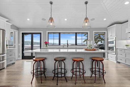 Incredible kitchen island with a stunning wall of windows that frame breathtaking lake views- enjoy effortless living in this wonderful space.