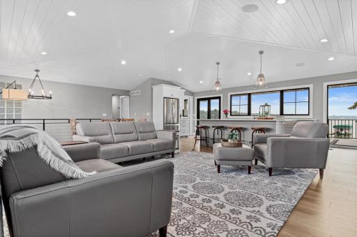 Bright and airy open-concept living with shiplap vaulted ceilings that add charming character and spaciousness to the kitchen, dining, and living areasâperfect for modern lake living and entertaining.