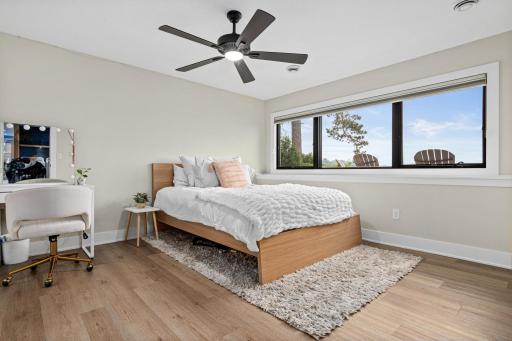 The lower-level bedroom offers privacy and a wonderful view of the lake. Located adjacent to the 3/4 bathroom- perfect for guests or family.