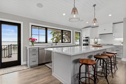The large center island is the heart of the kitchen, perfect for gathering and entertaining. Abundant cabinetry, beautiful solid surface countertops, and newer appliances combine style and function to make this space truly shine.