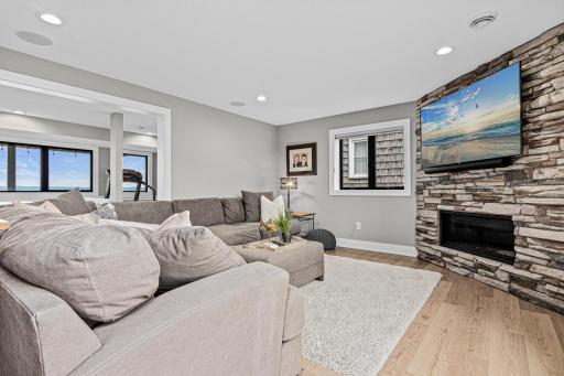 The family room has a cozy gas fireplace and multiple areas for fun and games.