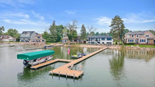The ultimate lake setupâdock with room for all your water toys, a shallow sandy beach with a gradual drop-off, and a stunning view back to the beautifully updated home.