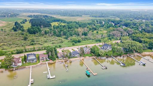 Spectacular drone view showcasing the prime County Road I location, looking south over Turtle Lake, with peaceful Ramsey County open space just beyond the backyardâprivacy and nature at your doorstep.