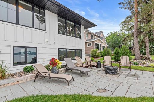 Newly installed patio pavers surround a cozy fire pitâperfect for lakeside fires, roasting sâmores, sharing campfire stories, or relaxing under the stars.