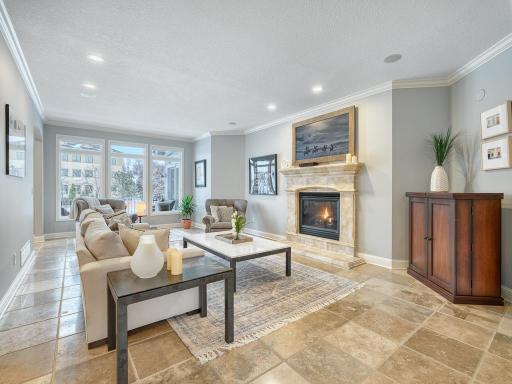 Main level family room with gas fireplace and custom tiled floors.