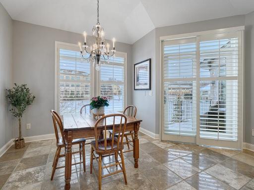 Informal dining area surrounded by windows and flows out to the maintenance free deck.