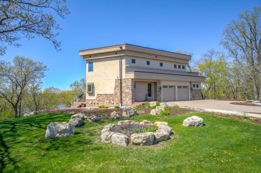 Set on more than two acres with over 200ft of river frontage, this thoughtfully crafted home blends contemporary design with warm, inviting elements, creating a stylish and serene retreat perfect for both relaxation and entertaining.