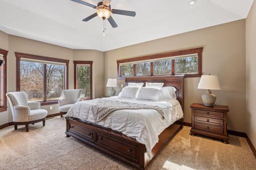 The main level primary bedroom suite features its own zone for heating and cooling, remote controlled window treatments, and a walk-in closet with laundry!