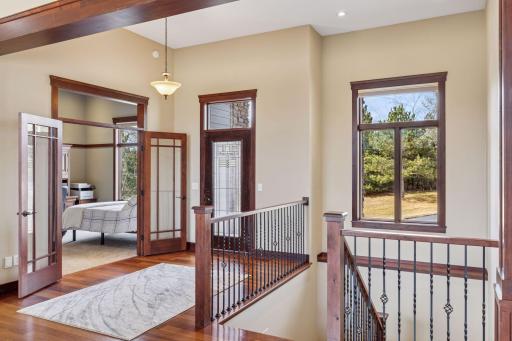 Beautiful woodwork and railing details heading downstairs.