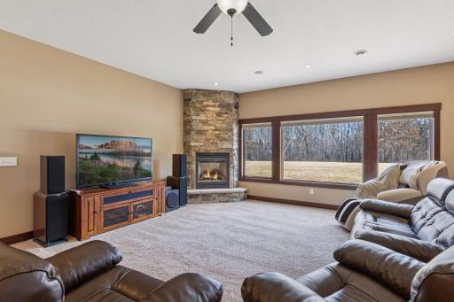 This family room features the 3rd stone gas fireplace in the home.