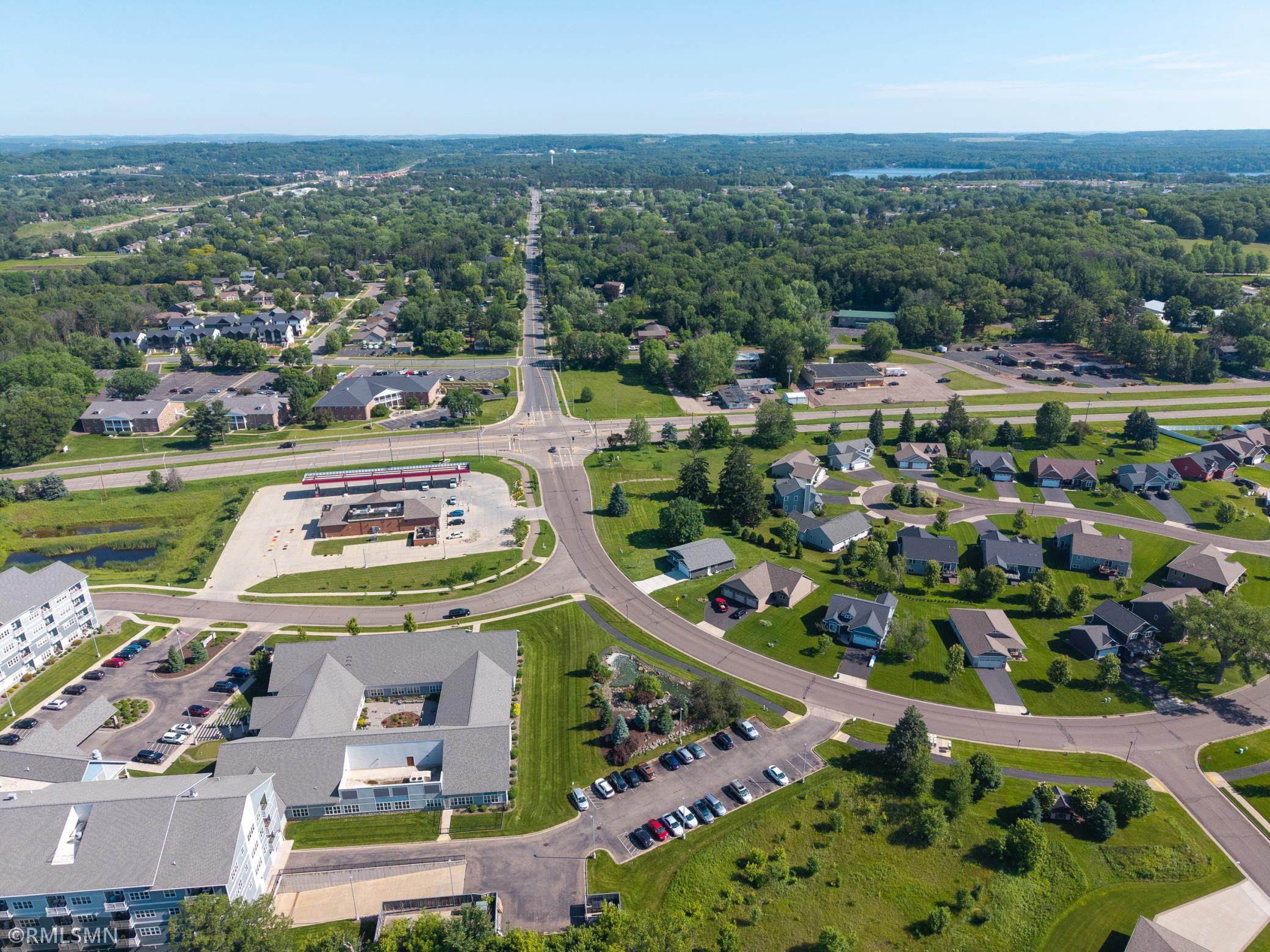 Aerial view displaying nearby amenities, roads, and the lot location in context with the area.
