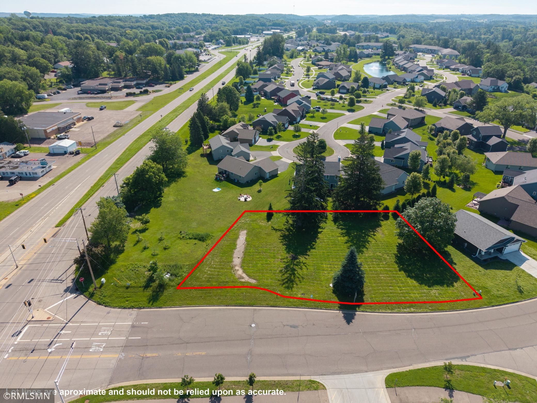 Aerial shot highlighting green spaces, mature trees, and neighborhood layout.