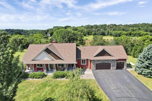 A stunning front view of the home showcases freshly painted cement board that perfectly highlights charming stone accents, creating a warm and inviting atmosphere.