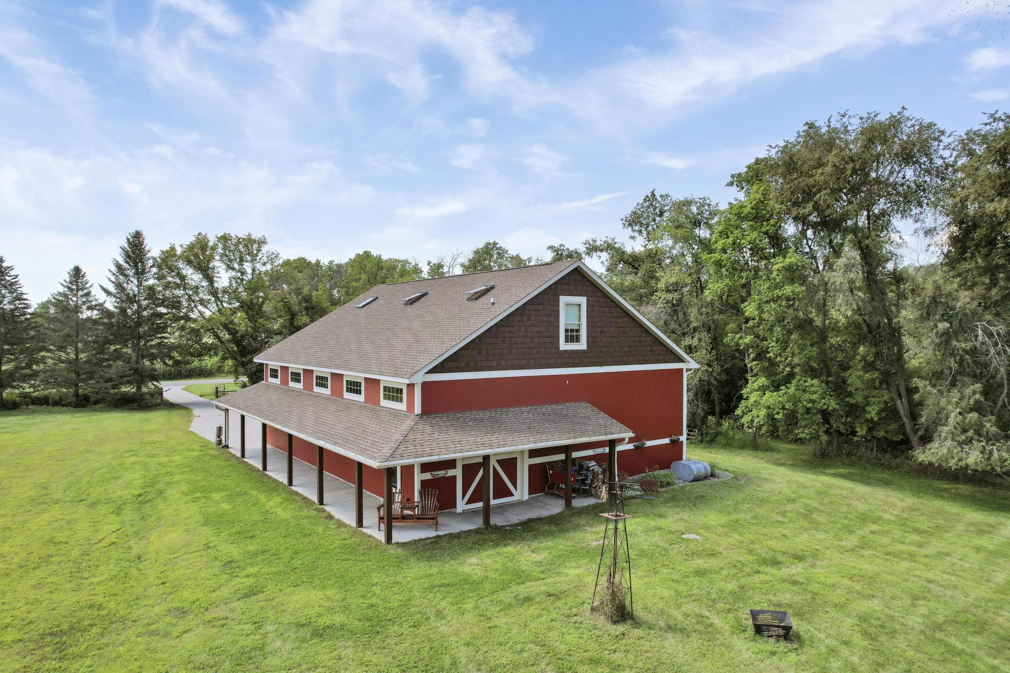 This charming 60x40 outbuilding is fully finished and features a lovely overhang, a convenient half bathroom, and a spacious upper-level bonus room. This versatile space has endless possibilities!