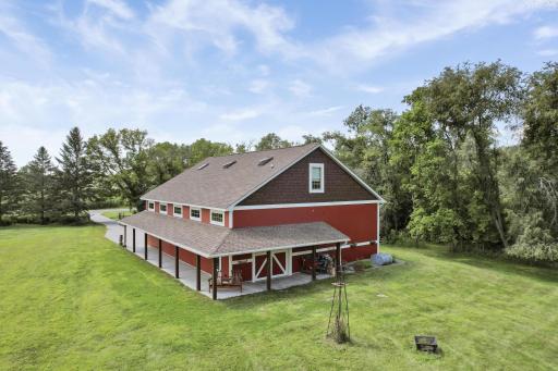 This charming 60x40 outbuilding is fully finished and features a lovely overhang, a convenient half bathroom, and a spacious upper-level bonus room. This versatile space has endless possibilities!