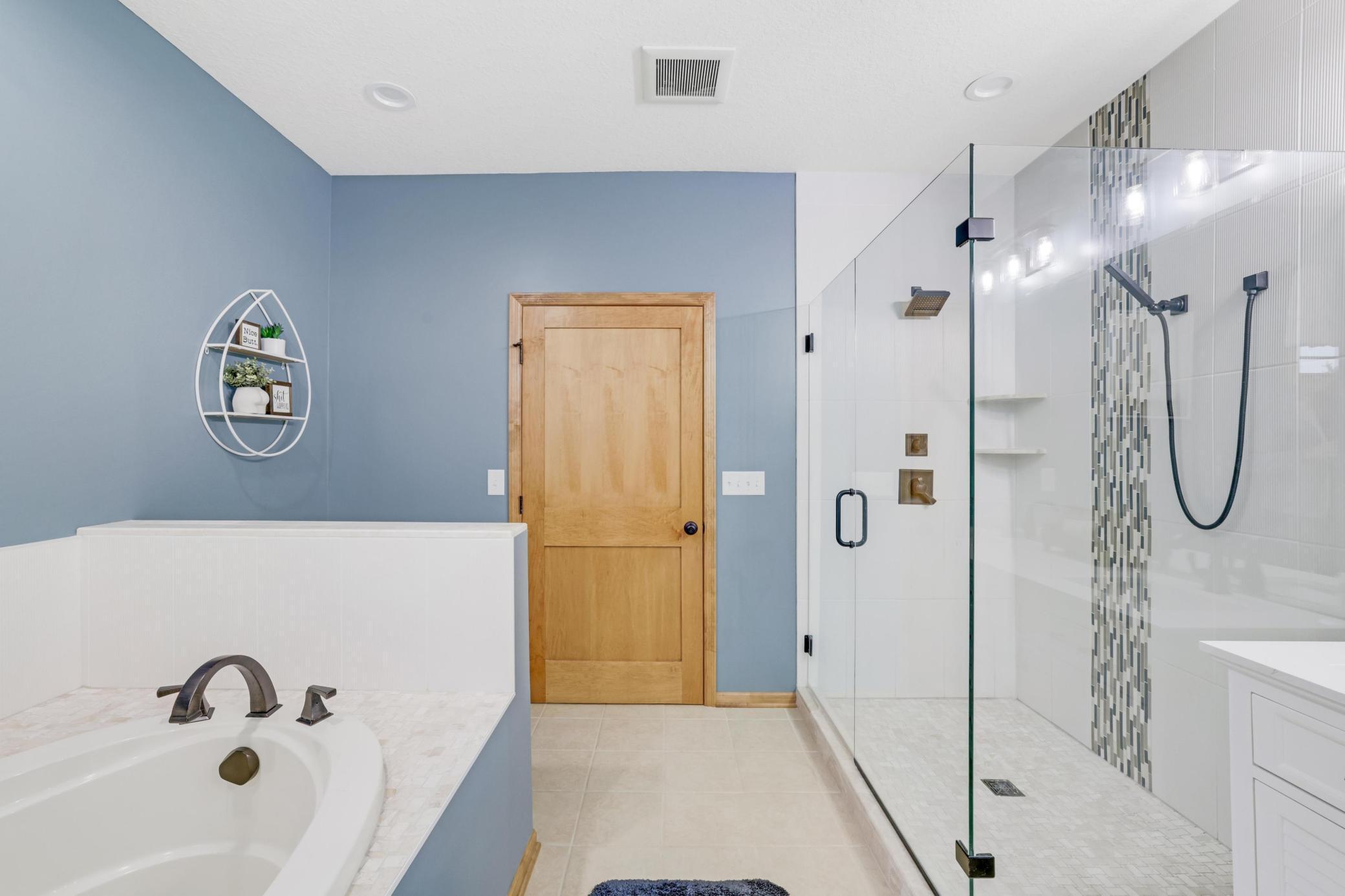 Primary bathroom complete with a luxurious walk-in tile shower, double sinks and spacious soaking tub. Transform your daily rituals into a spa-like experience!
