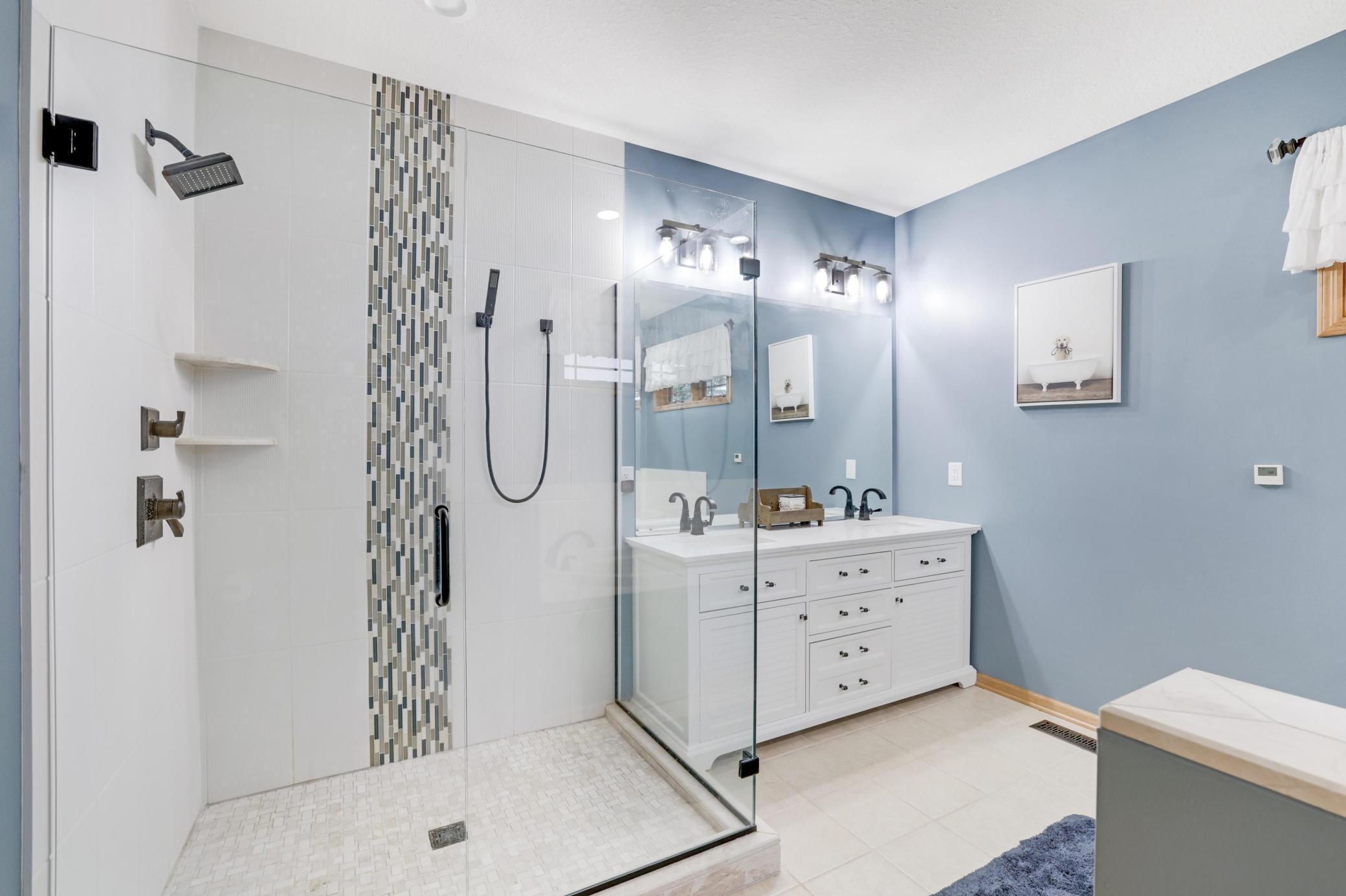Primary bathroom complete with a luxurious walk-in tile shower, double sinks and spacious soaking tub. Transform your daily rituals into a spa-like experience!