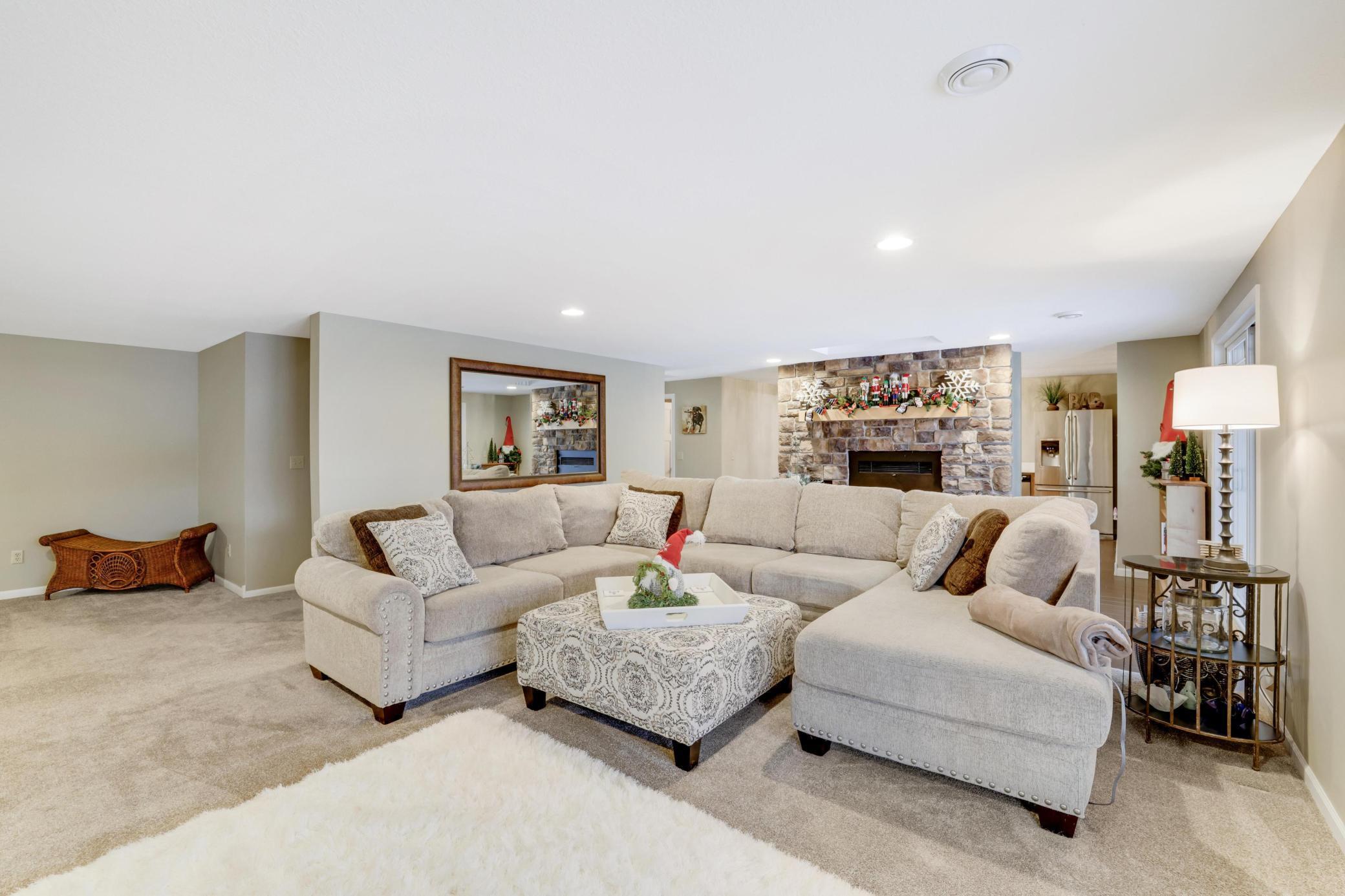 Step into the inviting lower level living room, where cozy wood-burning fireplace sets the perfect ambiance. With a full secondary kitchen at your fingertips, this space seamlessly connects to the pool area, making it an ideal spot for entertaining!