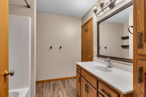 Full upper level bathroom with a large vanity.