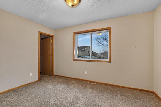 Spacious upper level bedroom with a walk in closet.