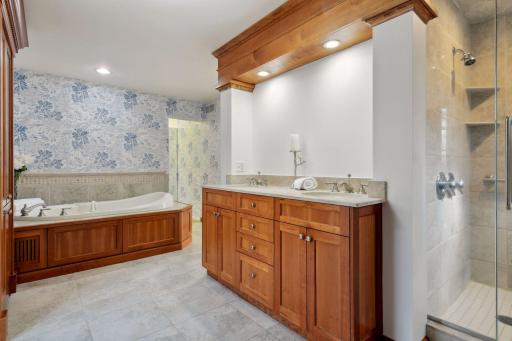 Primary bath with walk-in shower, dual sinks, and whirlpool tub