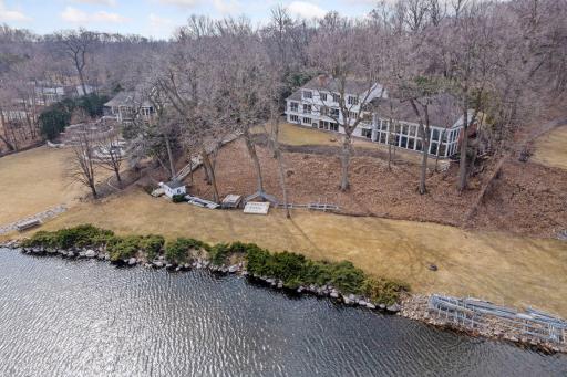 Aerial view of the back of the property and lake shore