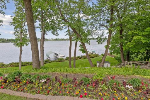Stairs lead to the lower level yard, dock, and lakeshore, as well as this storage shed